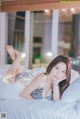 A woman laying on a bed in a leopard print bikini.