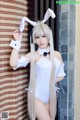 A woman in a bunny costume posing for a picture.