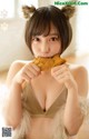 A woman in a furry outfit eating a piece of food.